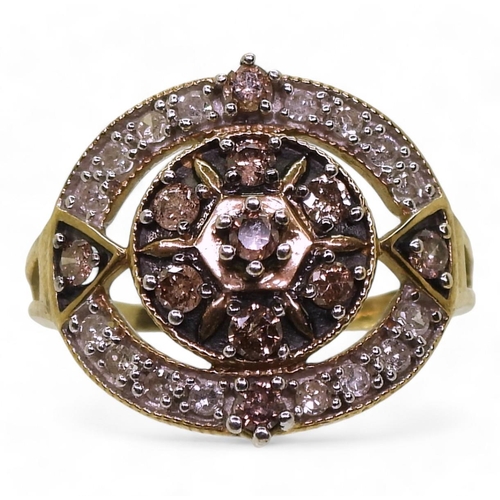 767 - A yellow metal ring set with champagne and white diamonds, set with estimated approx 0.65cts of bril... 