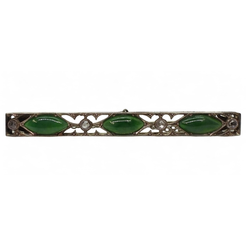 822 - A vintage green hardstone brooch, craftsman made with pierced mount and cut back settings, mounted w... 