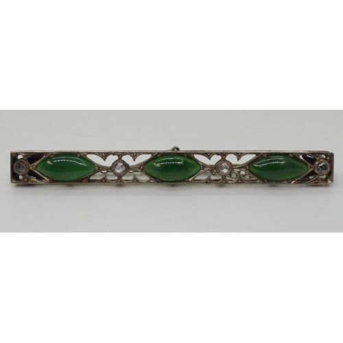 822 - A vintage green hardstone brooch, craftsman made with pierced mount and cut back settings, mounted w... 