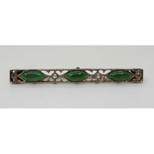 822 - A vintage green hardstone brooch, craftsman made with pierced mount and cut back settings, mounted w... 