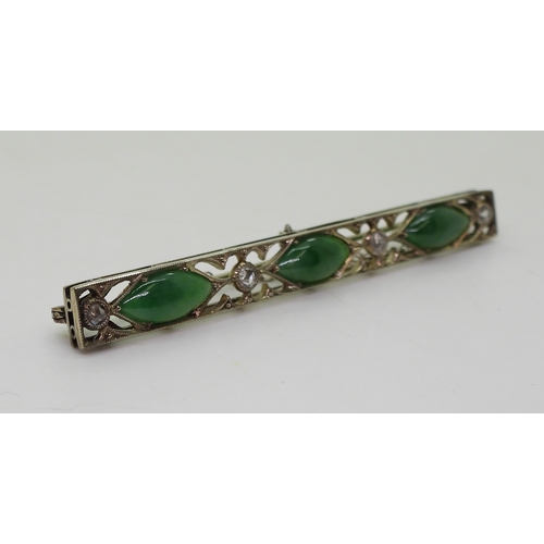 822 - A vintage green hardstone brooch, craftsman made with pierced mount and cut back settings, mounted w... 