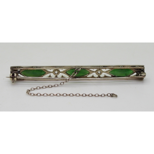 822 - A vintage green hardstone brooch, craftsman made with pierced mount and cut back settings, mounted w... 