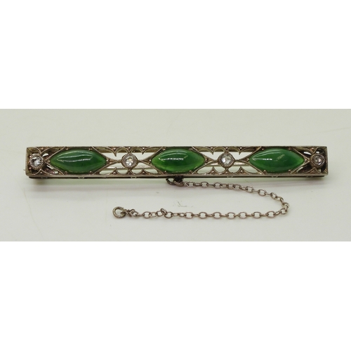 822 - A vintage green hardstone brooch, craftsman made with pierced mount and cut back settings, mounted w... 