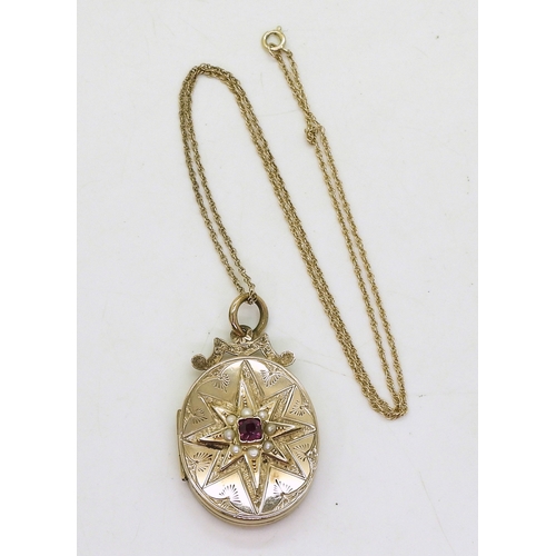 769 - A decorative locket, the yellow metal locket is engraved with a star to the front, set with split pe... 