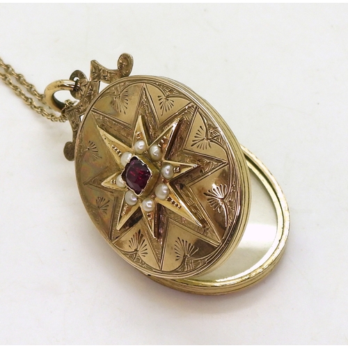 769 - A decorative locket, the yellow metal locket is engraved with a star to the front, set with split pe... 