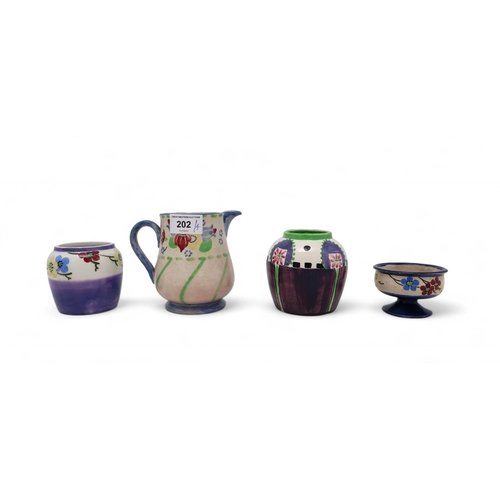 202 - A small collection of Scottish Bough pottery including a jug, salt, and two vases, all painted with ... 