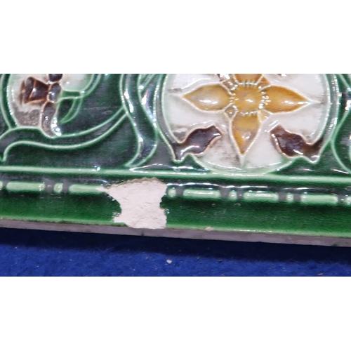 224 - A collection of half tiles, with tube line decoration of daffodils on a cream and green ground (76)