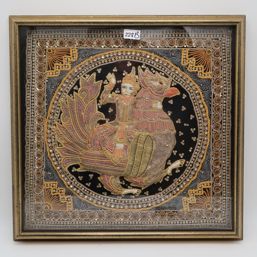 228B - A framed Thai embroidered tapestry panel, depicting a figure and an animal