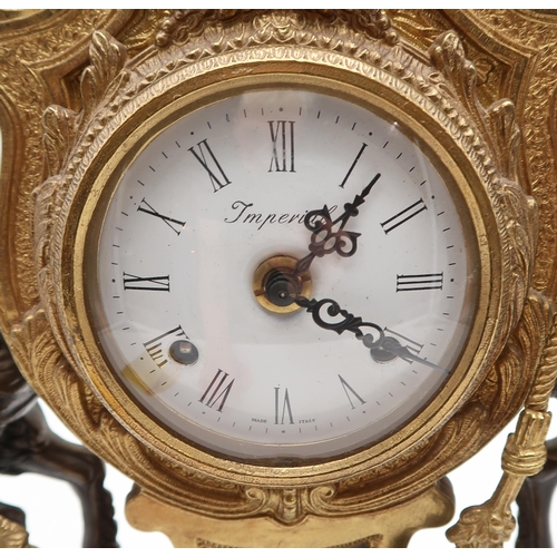 235 - An Italian Imperial clock, mounted with cherubs on a white enamel base