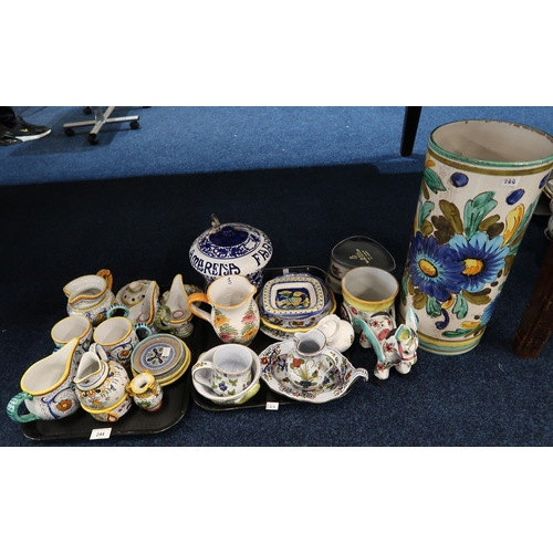 244 - A collection of Italian faience pottery including mugs, candlestands, dishes etc