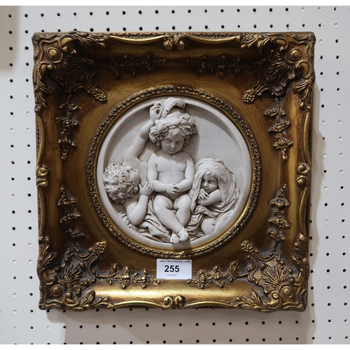 255 - A plaque depicting cherubs in a gilt frame