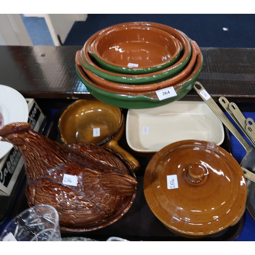 264 - A graduated set of copper frying pans, terracotta oven dishes and a hen egg nest