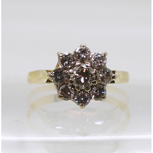 802 - A diamond flower ring, set with estimated approx 0.70cts of brilliant cut diamonds, finger size O1/2... 