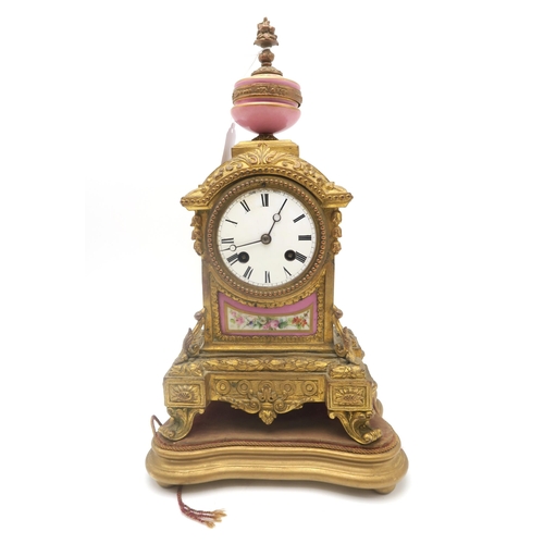 204 - A French mantel clock, with pink porcelain panel and finial, the white enamel dial with roman numera... 