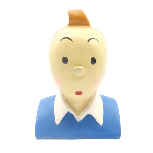 548 - A large composite plastic Tintin bust, measuring approx. 32cm in height; together with a small rug d... 