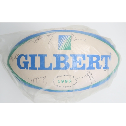 571 - A Gilbert 1995 Rugby World Cup official match ball, bearing numerous player signatures; together wit... 