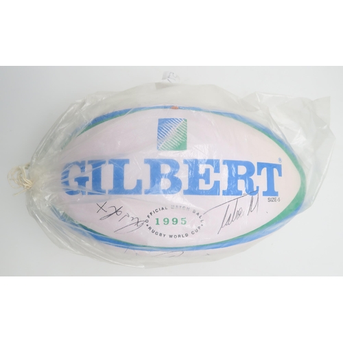 571 - A Gilbert 1995 Rugby World Cup official match ball, bearing numerous player signatures; together wit... 