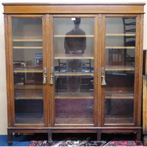 105 - An early 20th century Scottish Co-Operative Wholesale Society Ltd oak glazed bookcase with three gla... 