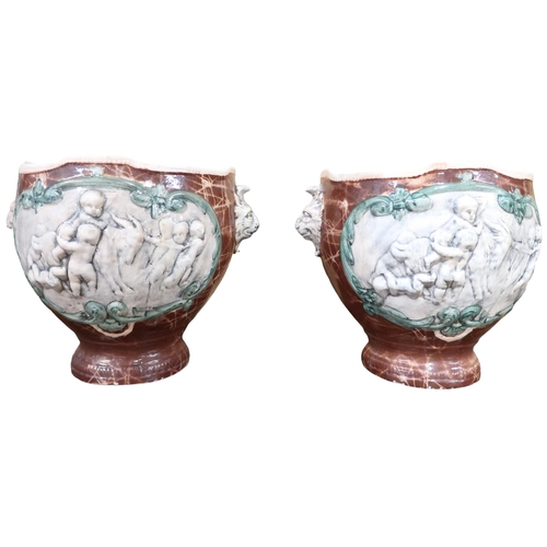 11 - A pair of ceramic decorative planters decorated with children playing with a goat and lion masque fi... 