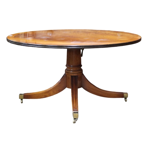 21 - A 20th century mahogany circular topped coffee table on quadrupedal base, 55cm high x 107cm diameter