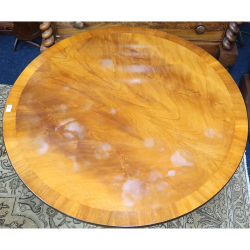 21 - A 20th century mahogany circular topped coffee table on quadrupedal base, 55cm high x 107cm diameter