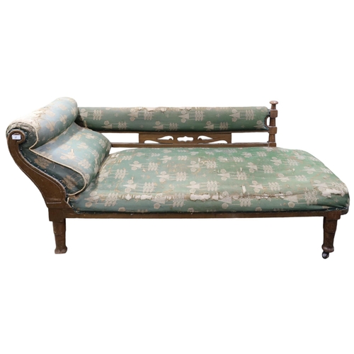 27 - A late Victorian oak framed Arts & Crafts style chaise longue with green patterned upholstery on... 