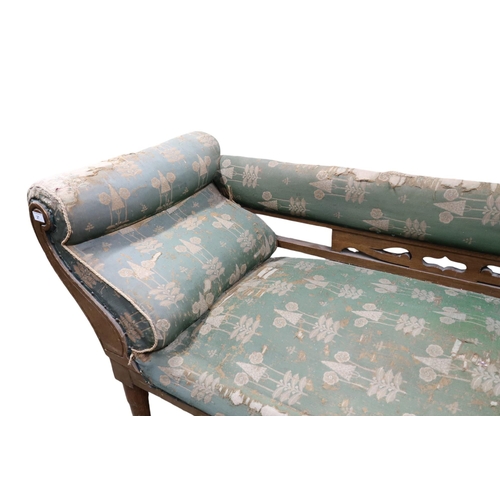 27 - A late Victorian oak framed Arts & Crafts style chaise longue with green patterned upholstery on... 