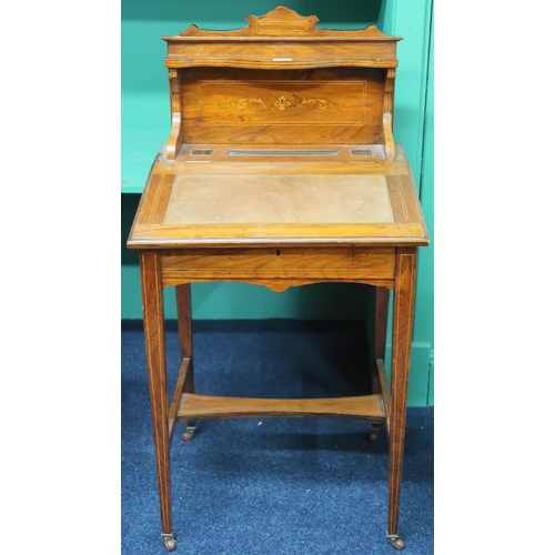 40 - A 19th century walnut ladies writing desk with serpentine shelf over hinged writing surface on squar... 