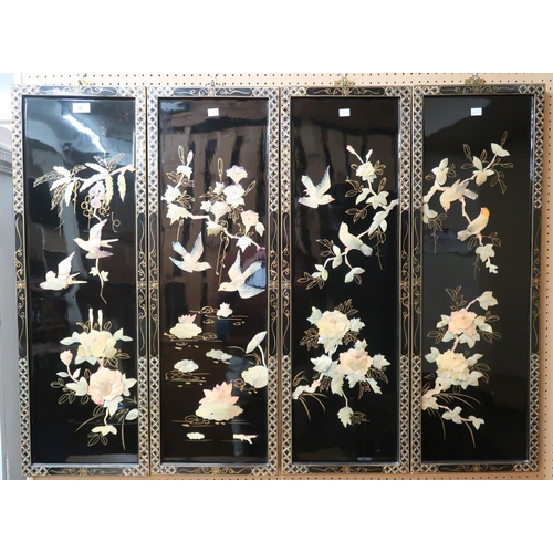 46 - A set of four 20th century Chinese black lacquer wall panels decorated with stone birds amongst bran... 