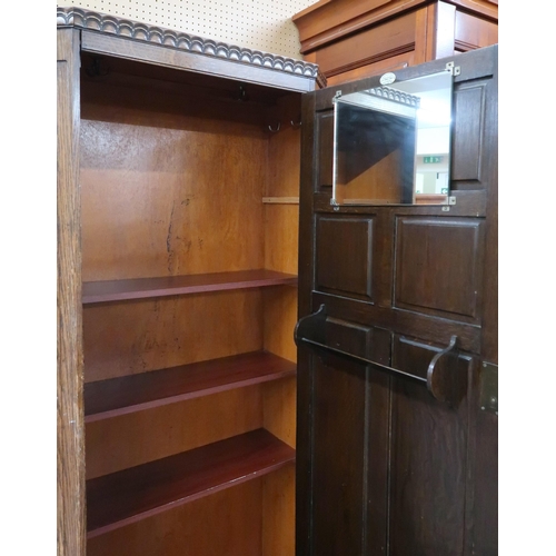 80 - An early 20th century oak hall robe with single panelled door on stepped feet, 178cm high x 85cm wid... 