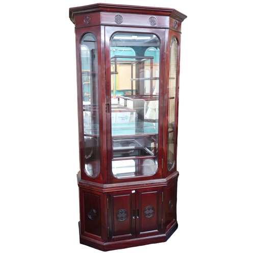 9 - A 20th century Chinese hardwood display cabinet with shaped cornice over single glazed door containi... 