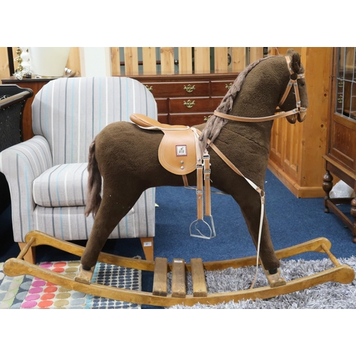 91 - A contemporary Mama's & Papa's child's rocking horse with leather bridle and saddle on wooden ba... 