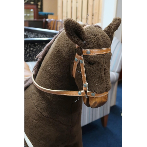 91 - A contemporary Mama's & Papa's child's rocking horse with leather bridle and saddle on wooden ba... 