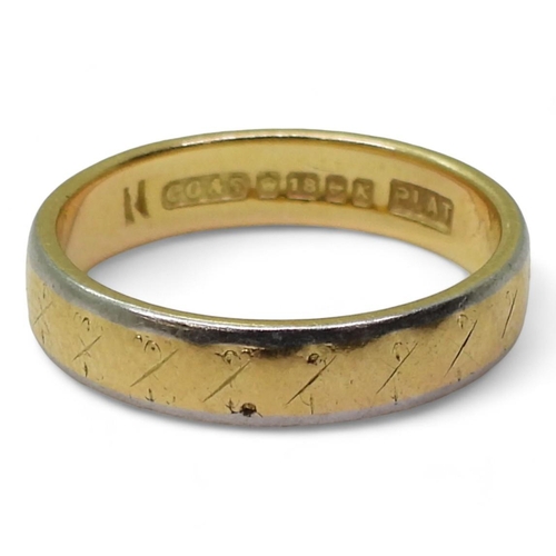 709 - An 18ct gold and platinum wedding ring, hallmarked Birmingham 1959, size L, weight 3.7gms