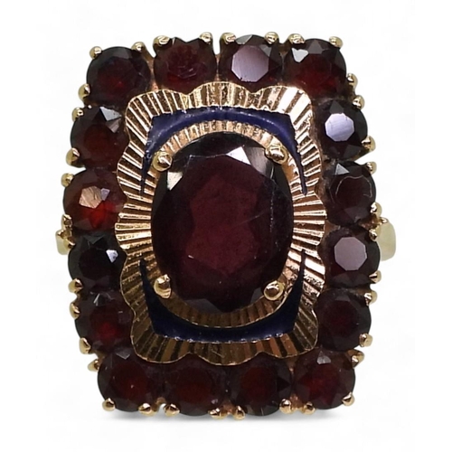 710 - A yellow metal garnet cluster ring, with enamelled details, stamped 750, size L1/2, weight 5.8gms