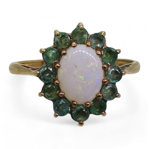 722 - A 9ct gold white opal and emerald cluster ring, finger size N1/2, weight 2gms