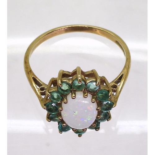 722 - A 9ct gold white opal and emerald cluster ring, finger size N1/2, weight 2gms