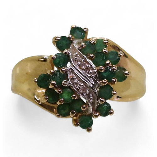 724 - A 10k gold emerald and diamond cluster ring, size N1/2, weight 3.7gms