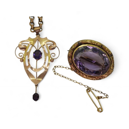 734 - A 9ct gold Edwardian pendant set with an amethyst with a yellow metal chain, and a large amethyst br... 