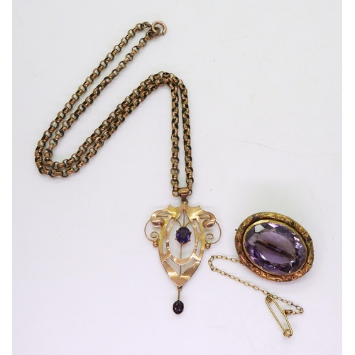 734 - A 9ct gold Edwardian pendant set with an amethyst with a yellow metal chain, and a large amethyst br... 