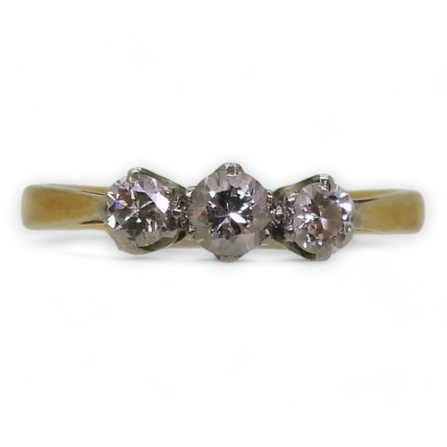 740 - An 18ct gold and platinum three stone diamond ring, set with estimated approx 0.30cts of brilliant c... 