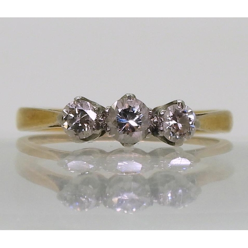 740 - An 18ct gold and platinum three stone diamond ring, set with estimated approx 0.30cts of brilliant c... 