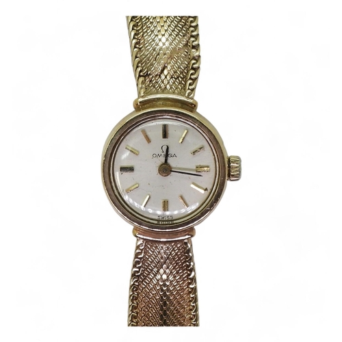 747 - A ladies Omega wristwatch with integral strap 17.5cm, weight including mechanism 18.2gms