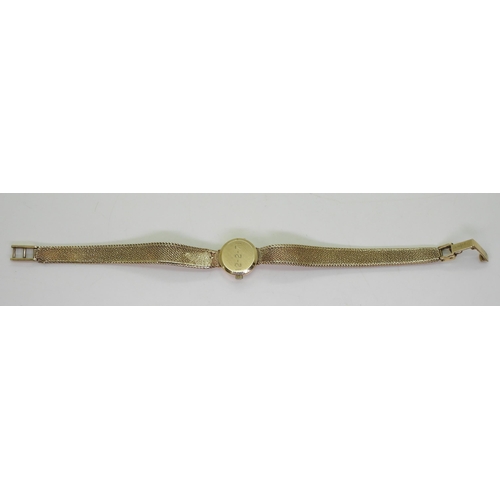 747 - A ladies Omega wristwatch with integral strap 17.5cm, weight including mechanism 18.2gms