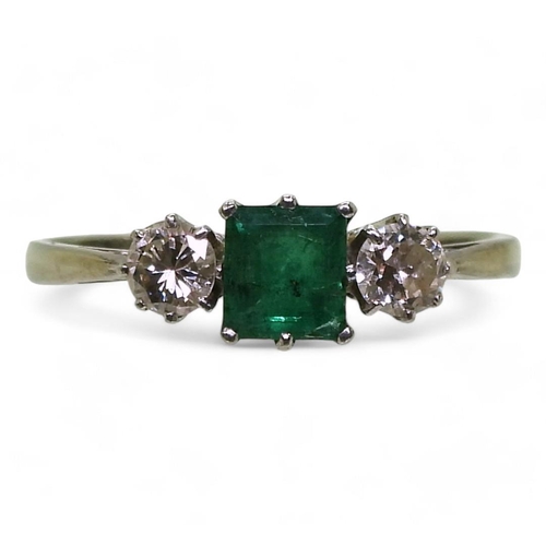 759 - An 18ct white gold and platinum emerald and diamond three stone ring, set with a square cut emerald ... 