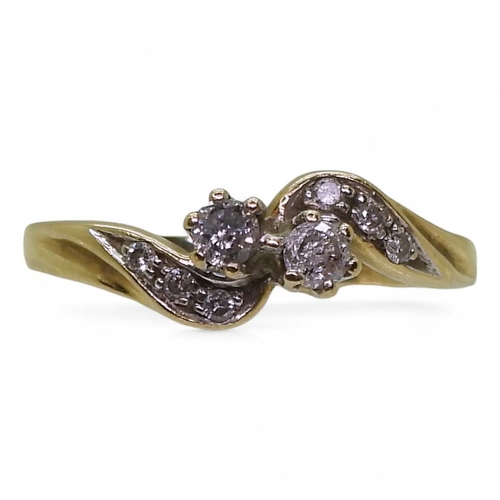 760 - A 9ct gold twin stone diamond ring on a twist, with further diamonds set to the shoulders with an es... 