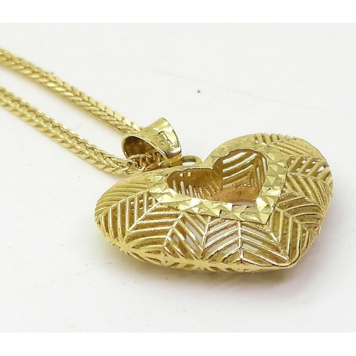 763 - A 9ct gold hollow heart pendant on a 50cm, fancy diamond cut herringbone chain, weight together 2.6g... 