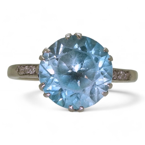 792 - A platinum set blue zircon ring, with diamond accent shoulders, size L, weight 4.5gms