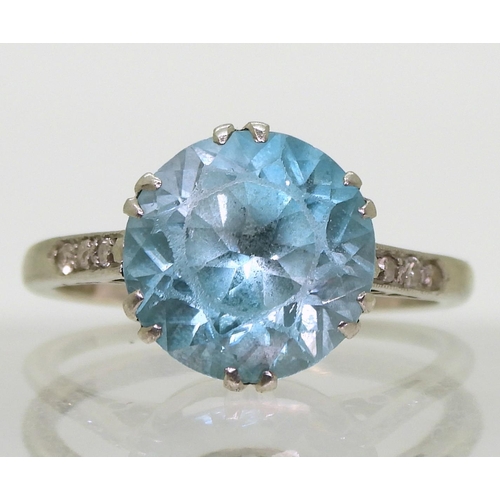 792 - A platinum set blue zircon ring, with diamond accent shoulders, size L, weight 4.5gms