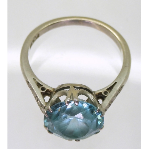 792 - A platinum set blue zircon ring, with diamond accent shoulders, size L, weight 4.5gms